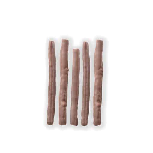 Overhead view of five chocolate-covered strips of orange peel laying on a white background.