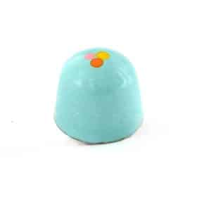 Side view of a blue gourmet bonbon with an orange, pink, and yellow dot; truffle tastes like peanut butter and pretzels