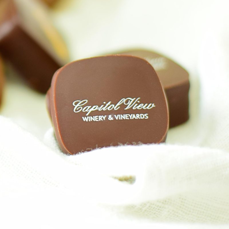 Two gourmet chocolate truffles that read Capital View Winery