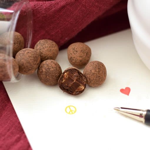 6 cocoa-powder covered balls that taste like espresso, chocolate, and caramel. One ball has a bite taken out of it