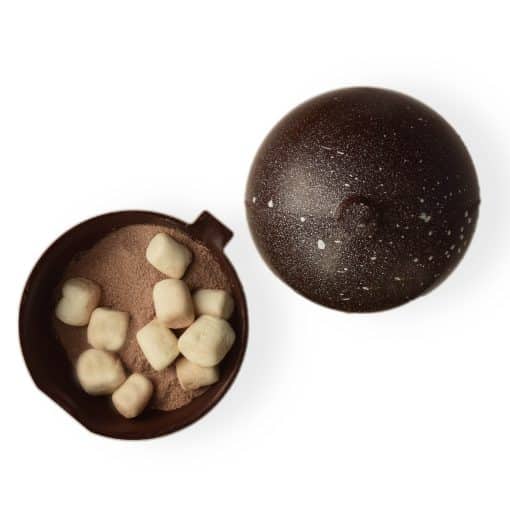 Ornament-shaped dark chocolate bomb; opened cocoa bomb reveals the gourmet sipping chocolate inside