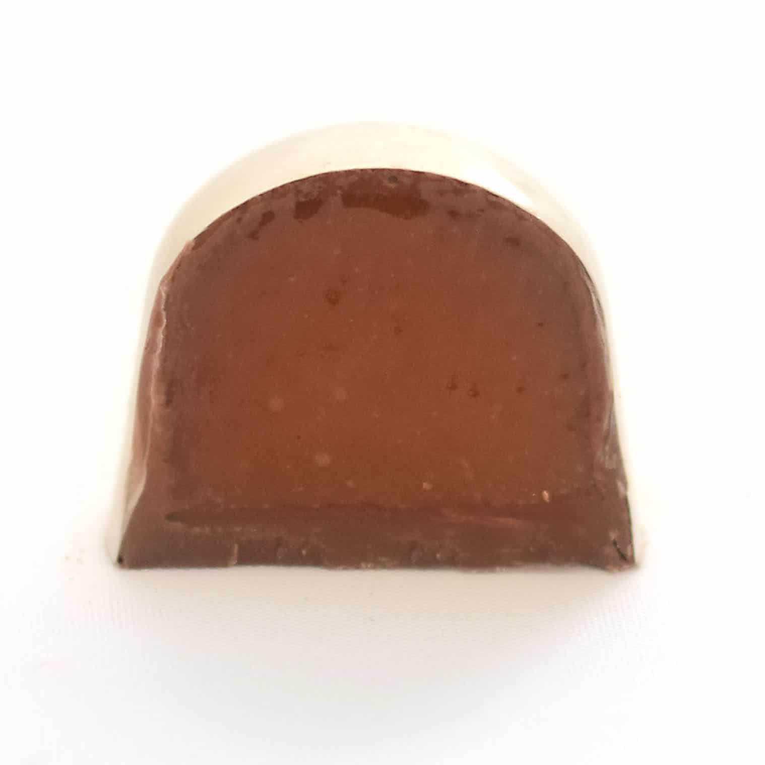 Inside view of a gourmet chocolate truffle that is filled with salted caramel