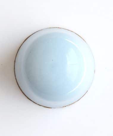Overhead view of a pale blue gourmet truffle that contains a layer of mascarpone ganache and a layer of coffee ganache
