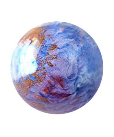 Overhead view of a bright blue gourmet chocolate truffle with brown swirls in. it; the truffle tastes like coconut and almonds
