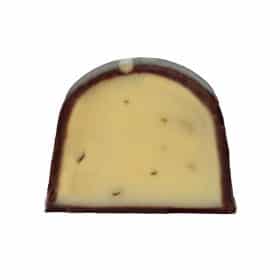 Inside view of a gourmet chocolate truffle that contains a light-green ganache with bits of mint leaves in it; the truffle tastes like mint