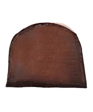 Inside view of a gourmet chocolate truffle that contains a jalapeno-infused dark chocolate ganache