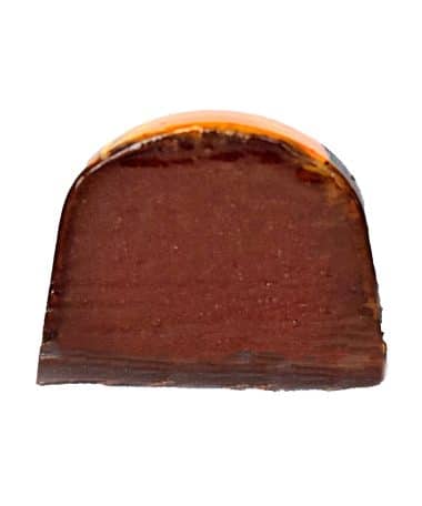 Inside view of a gourmet chocolate truffle that contains a dark chocolate and orange ganache