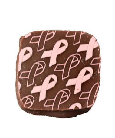Overhead view of a square gourmet chocolate bonbon with Breast Cancer Awareness Pink Ribbons on top; contains raspberry caramel