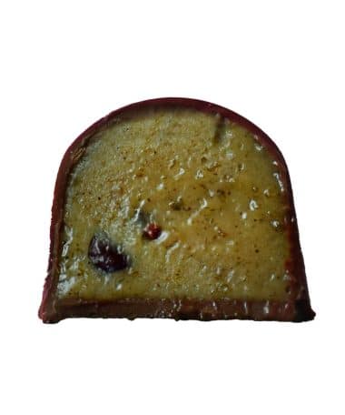 Inside view of a gourmet chocolate truffle that is filled with caramelized ripe bananas, warm spices, and crunchy nibs
