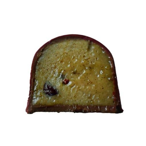 Inside view of a gourmet chocolate truffle that is filled with caramelized ripe bananas, warm spices, and crunchy nibs