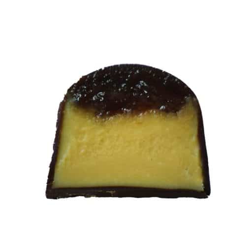 Inside view of a gourmet chocolate truffle that is filled with a layer of house-ground peanut butter ganache topped with a dollop of strawberry jelly