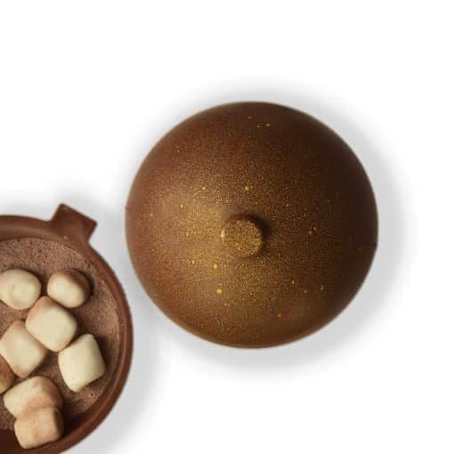 Overhead view of an ornament-shaped Milk Chocolate Cocoa Bomb with an inside view filled with cocoa mix and marshmallows