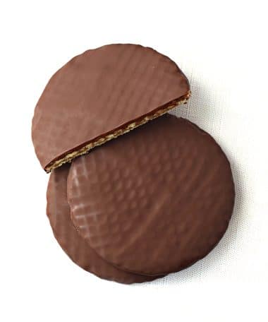 Overhead view of a stack of three dark chocolate covered stroopwafels