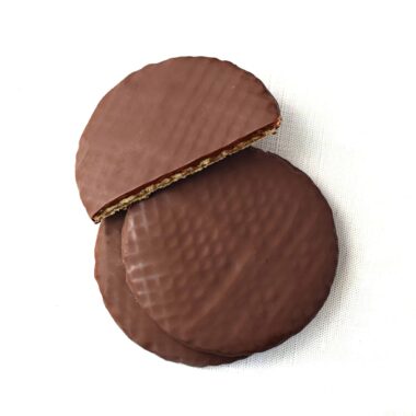 Overhead view of a stack of three dark chocolate covered stroopwafels