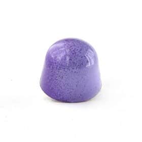 Side view of a purple ombre colored gourmet truffle that contains a whole almond, dairy-free caramel and almond gianduja