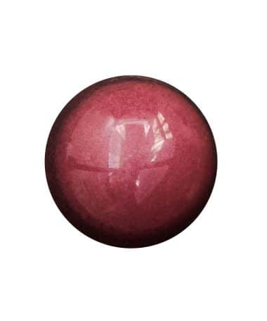 Overhead view of a deep pink gourmet chocolate bonbon that has a Cherry Almond filling
