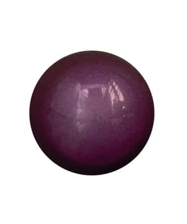 Overhead view of a purple-colored gourmet chocolate bonbon that is flavored with Cherry Cheesecake