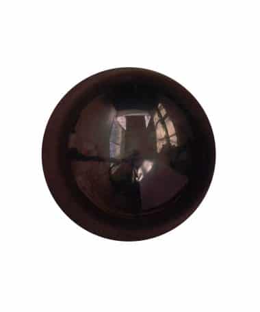 Overhead view of a shiny, dark gourmet chocolate bonbon that is flavored with double dark chocolate