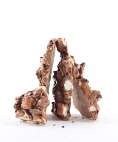 4 pieces of gourmet Peanut Rocky Road Bark standing on their ends to form a pyramid shape