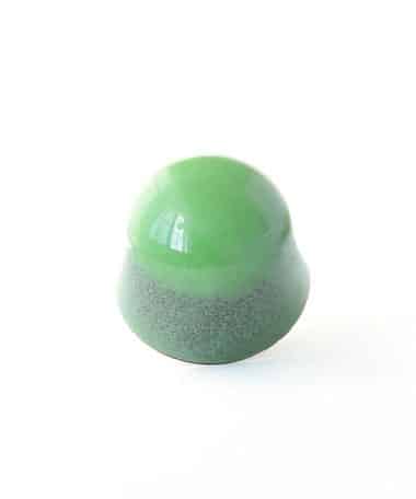 Leaf green gourmet chocolate truffle that contains a layer of cherry jelly and dark chocolate ganache