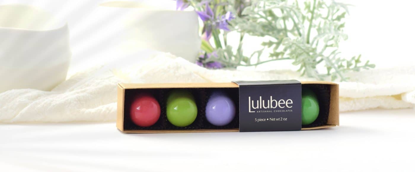5-piece box of spring-colored bonbons in a white setting