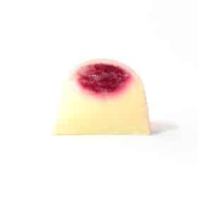 Inside view of a gourmet truffle with a top layer of raspberry jelly and a bottom layer of lemon ganache