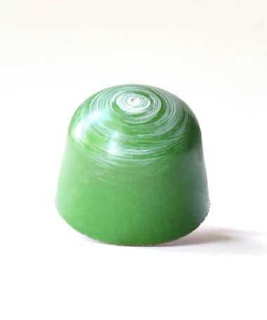 Leaf green gourmet bonbon with a white spiral on its top