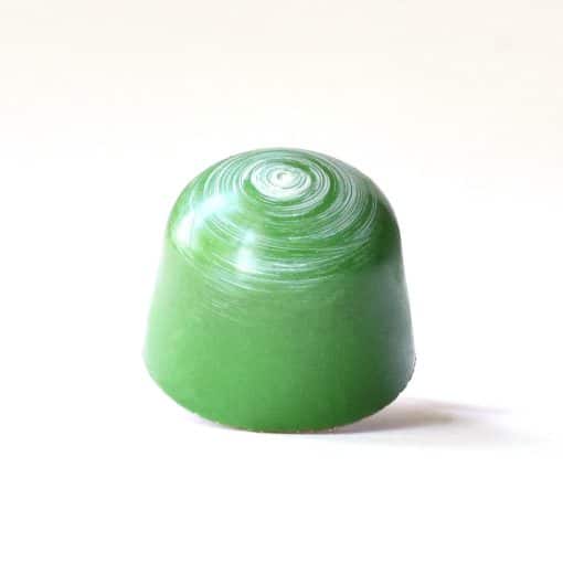 Leaf green gourmet bonbon with a white spiral on its top